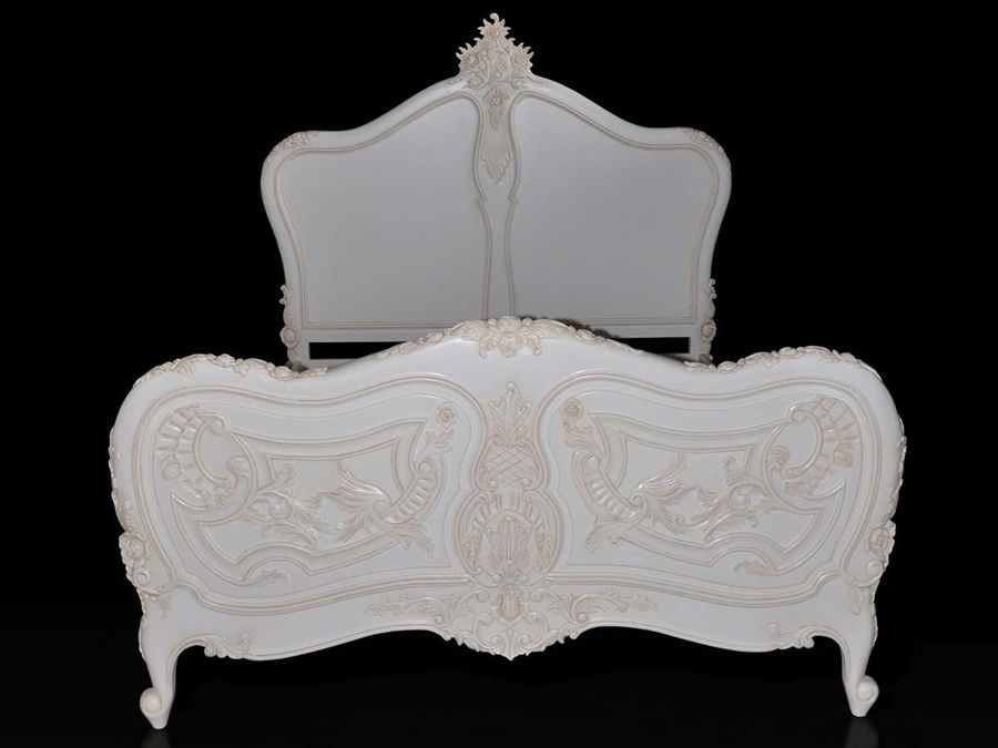 Rococo bed front view, the indentations on top and carving details of the foot board are shown.
