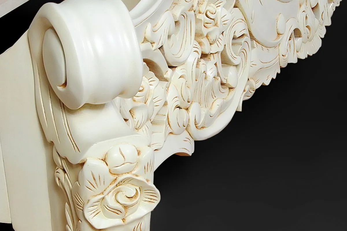 Footboard carving detail of white painted rococo bed